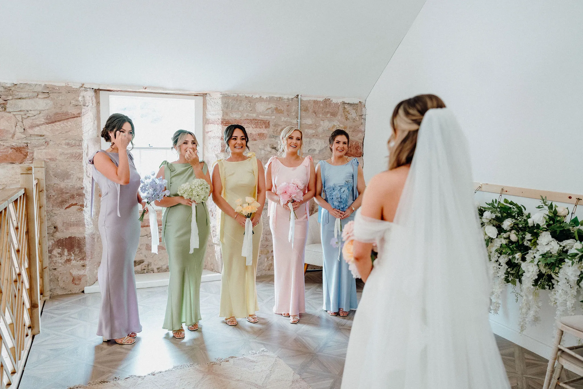Morning preparations at Broxmouth Courtyard with bridesmaids in pastel dresses.