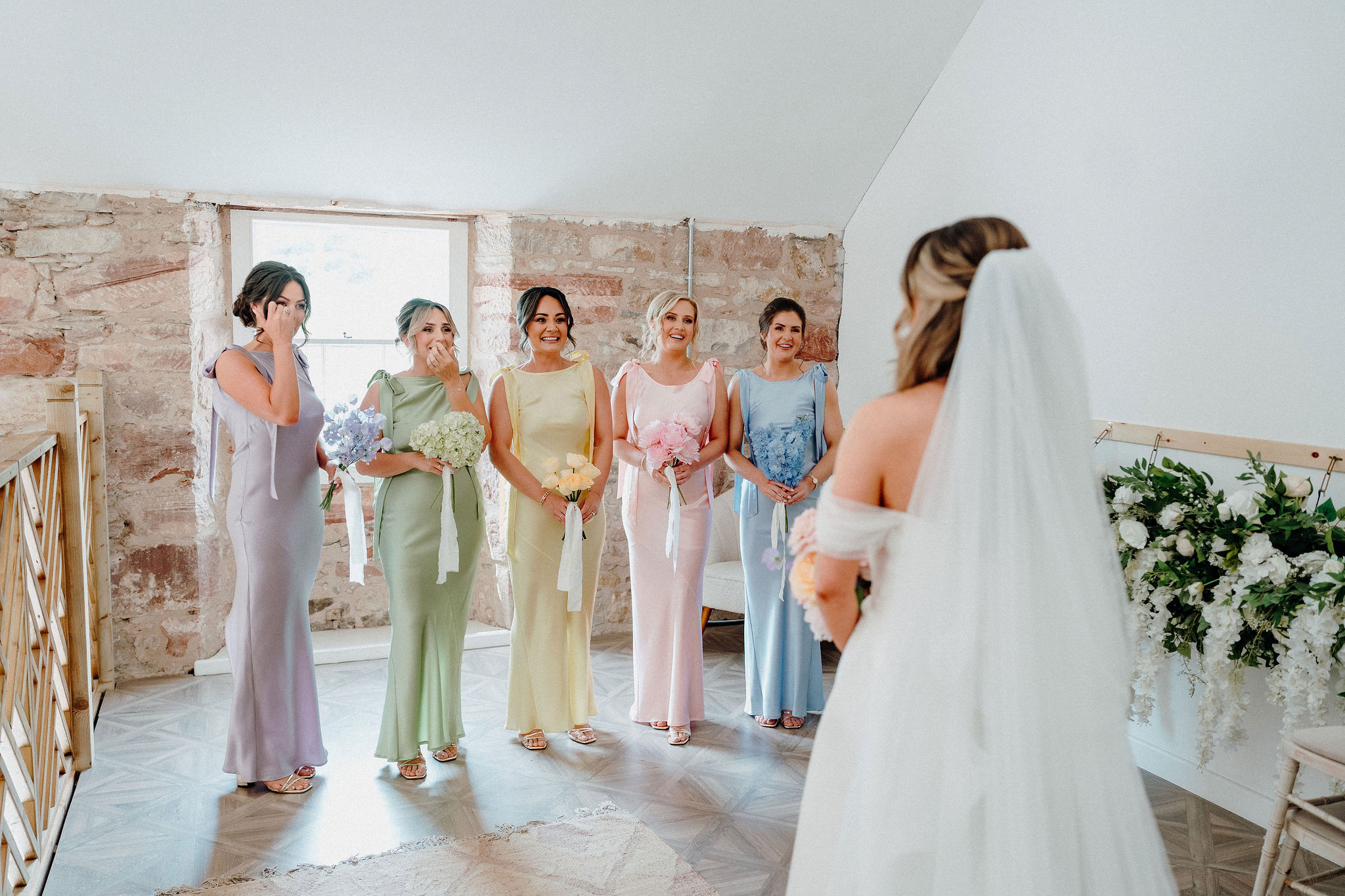 Morning preparations at Broxmouth Courtyard with bridesmaids in pastel dresses.